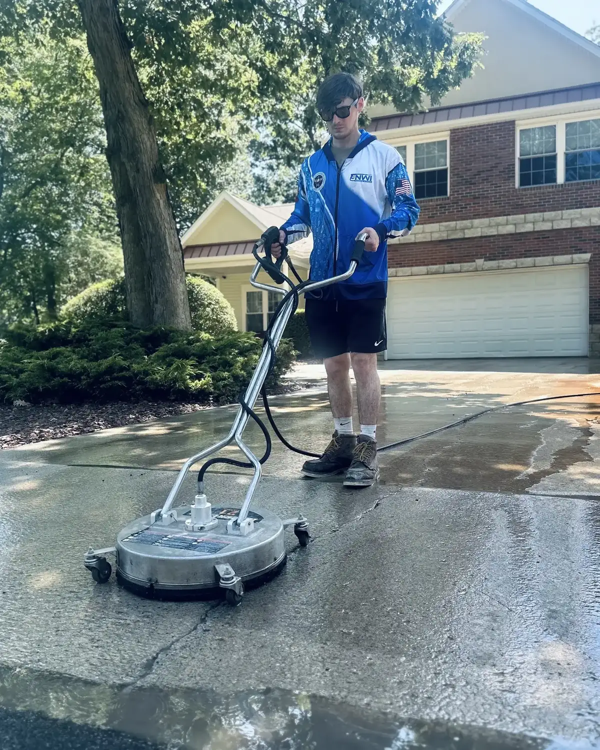 Ryan from NWI Pressure Washing surface cleaning a driveway in Sandy Pines, Wheatfield, Indiana