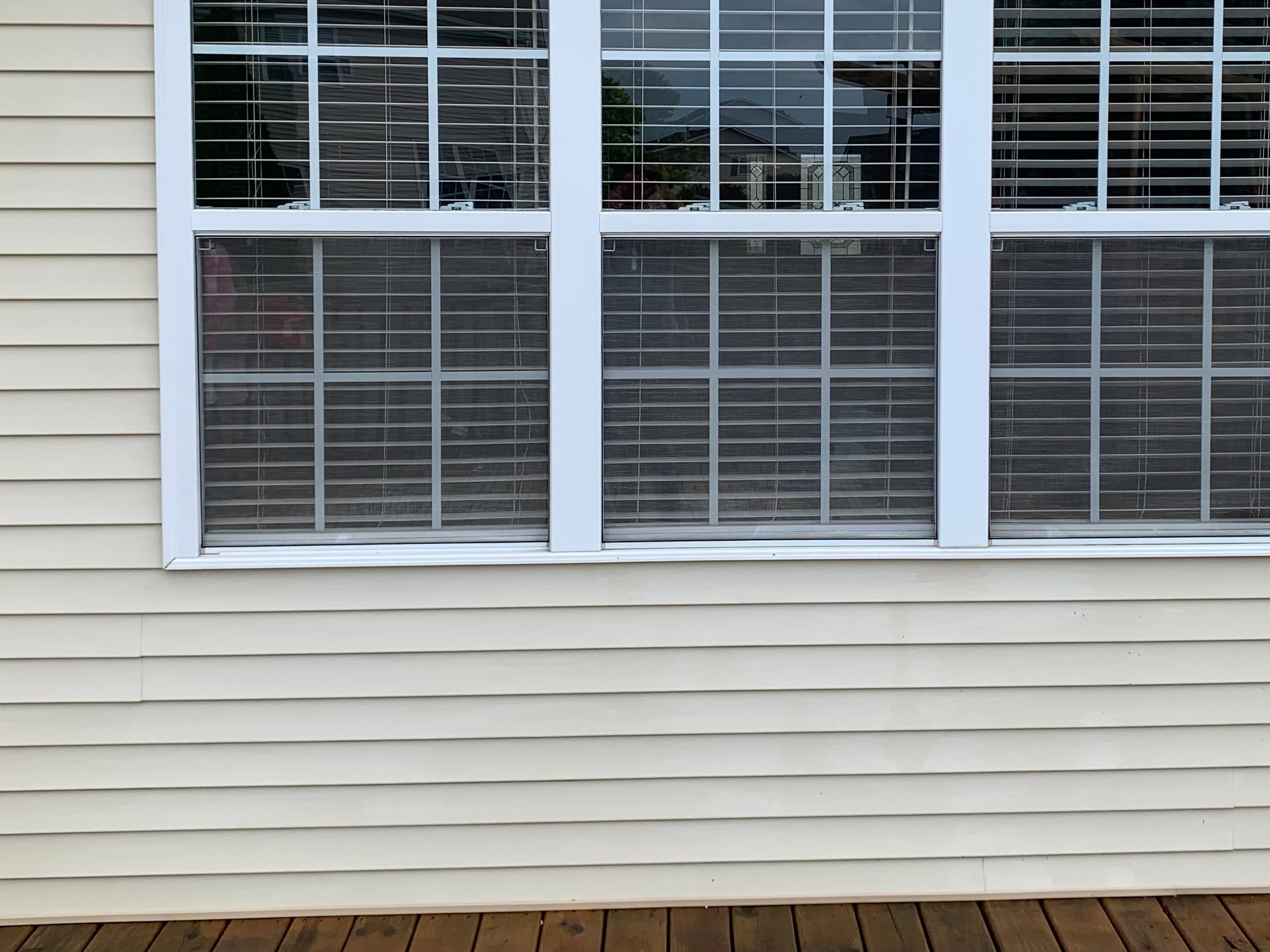 Spotless vinyl siding and deck in Hobart after NWI Pressure Washing, showcasing effective cleaning results.