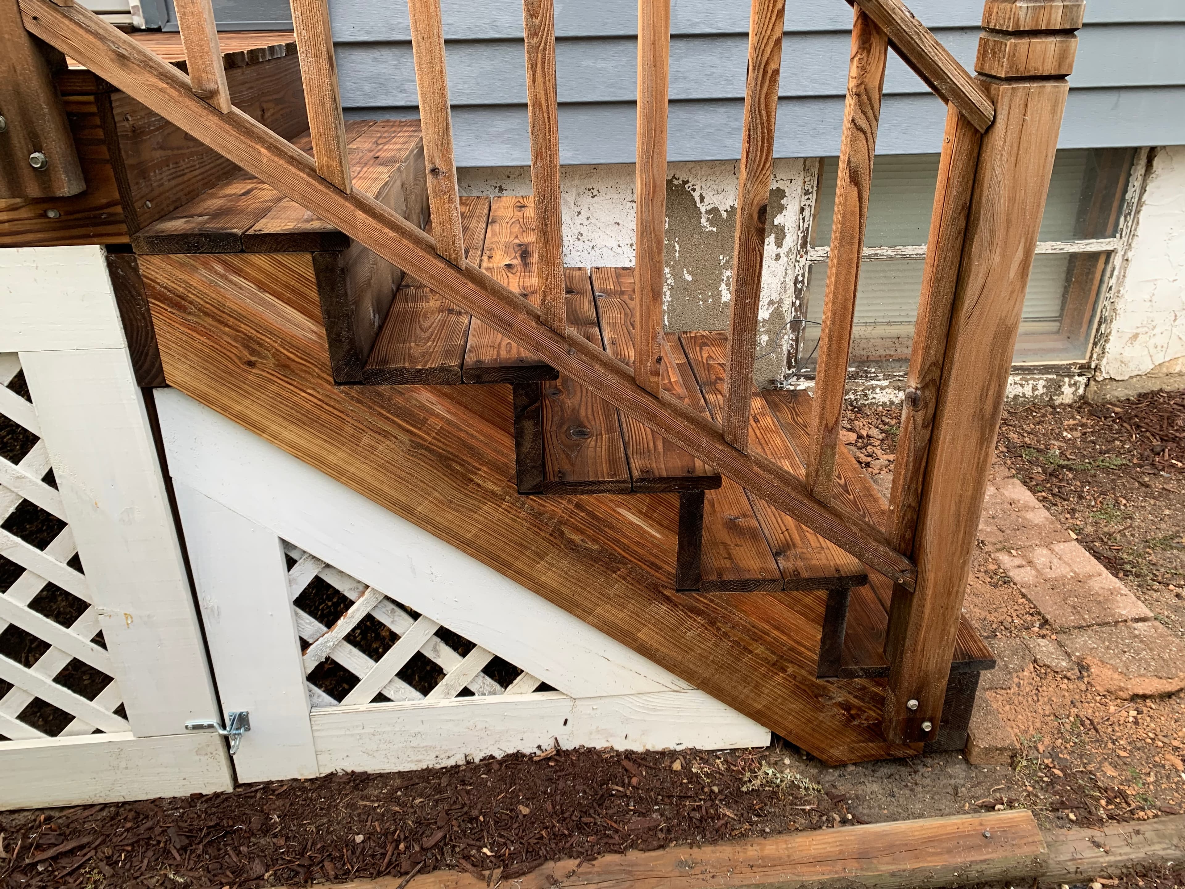 Freshly washed wooden stairs in Valparaiso display rich wood grain and clean surfaces after Fence Washing service.