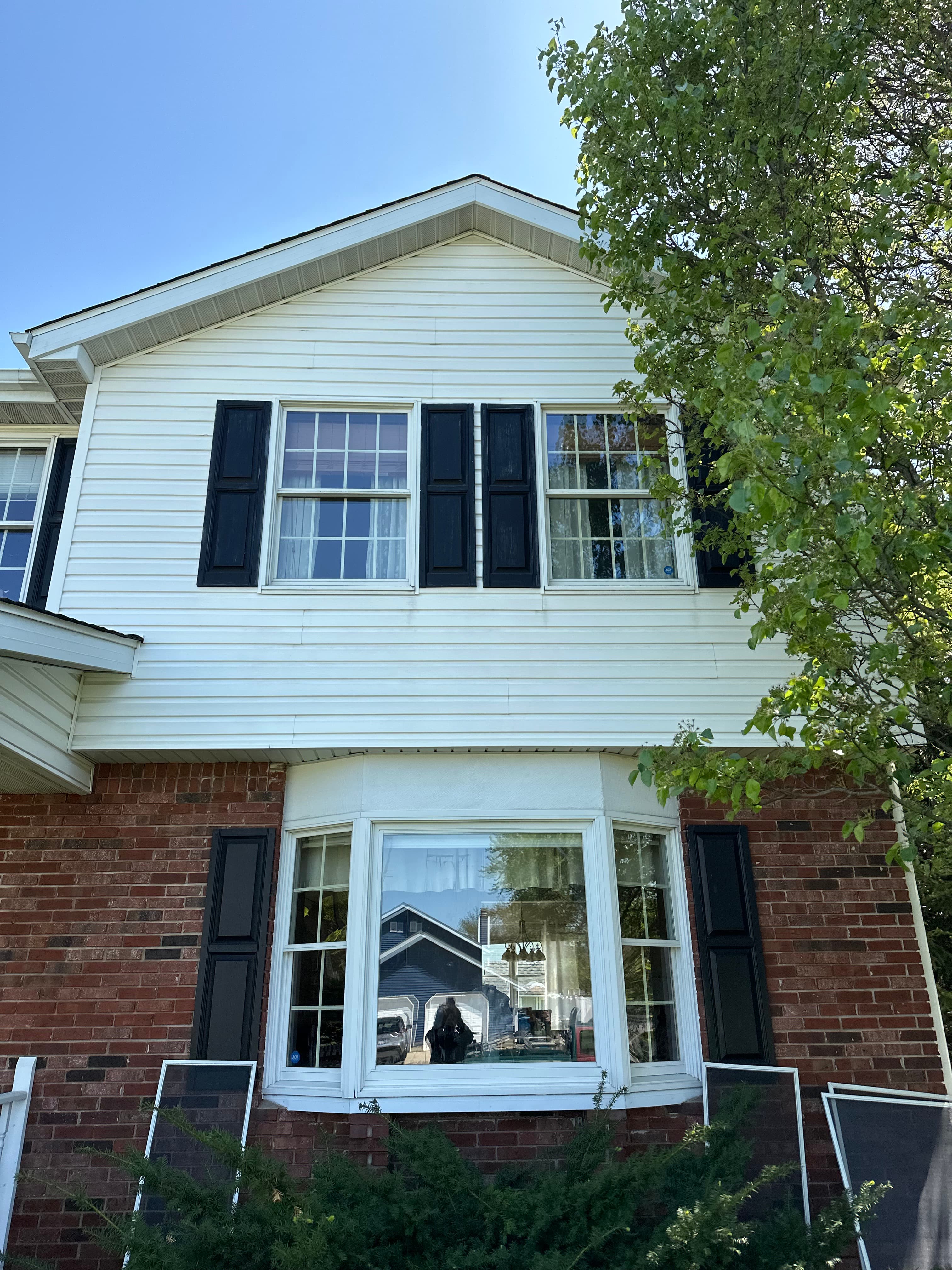 Brightened exterior of a Valparaiso home after House Washing, highlighting spotless windows and refreshed brick.