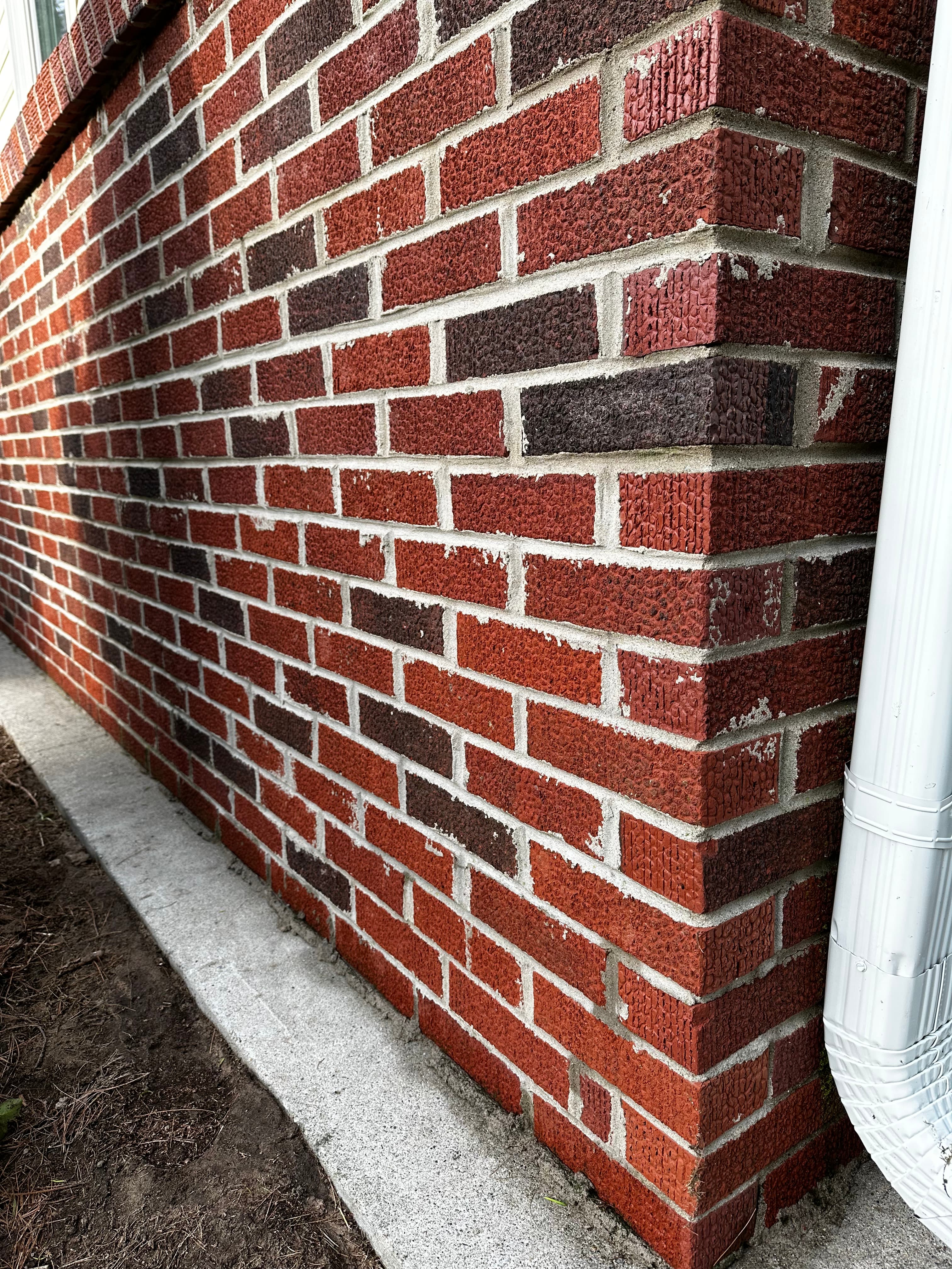 Clean red brick wall after house washing in Wheatfield, Indiana, displaying a pristine and vibrant surface.