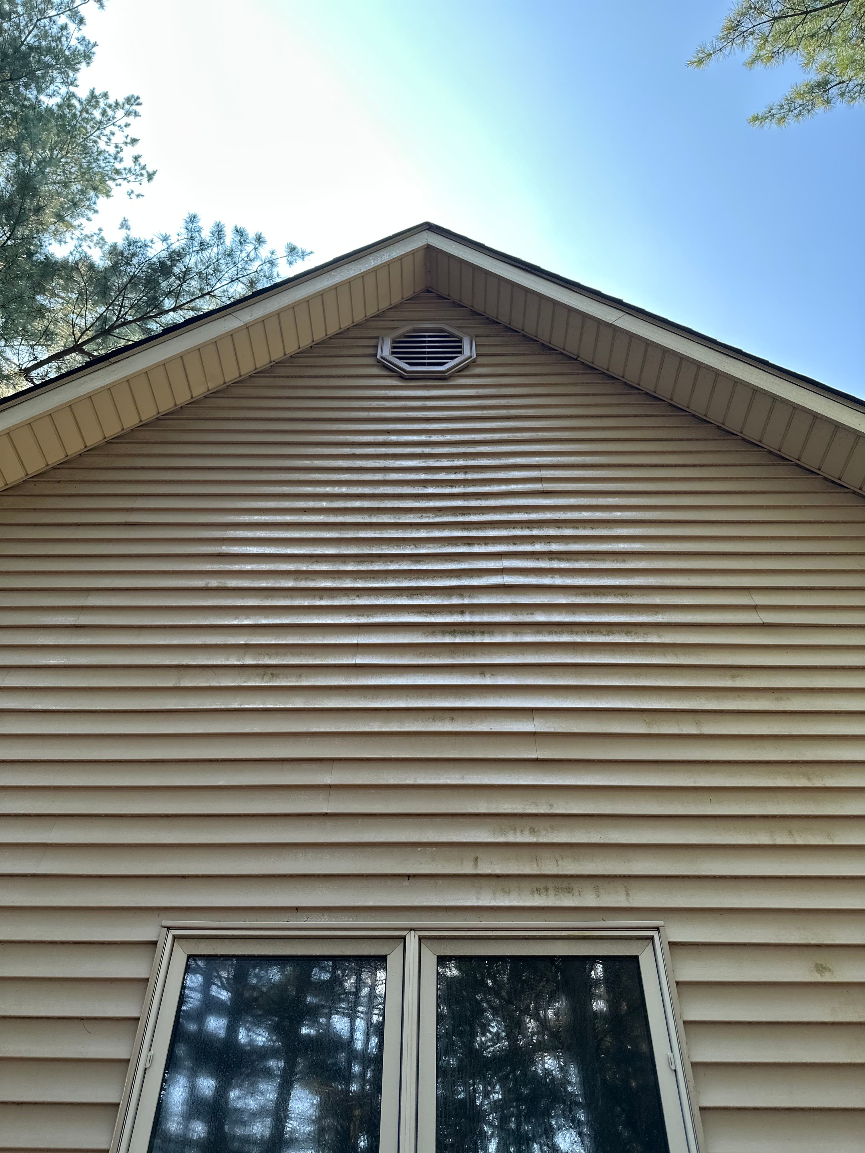 Front view of a house in Hobart with clean, streak-free vinyl siding after washing service.