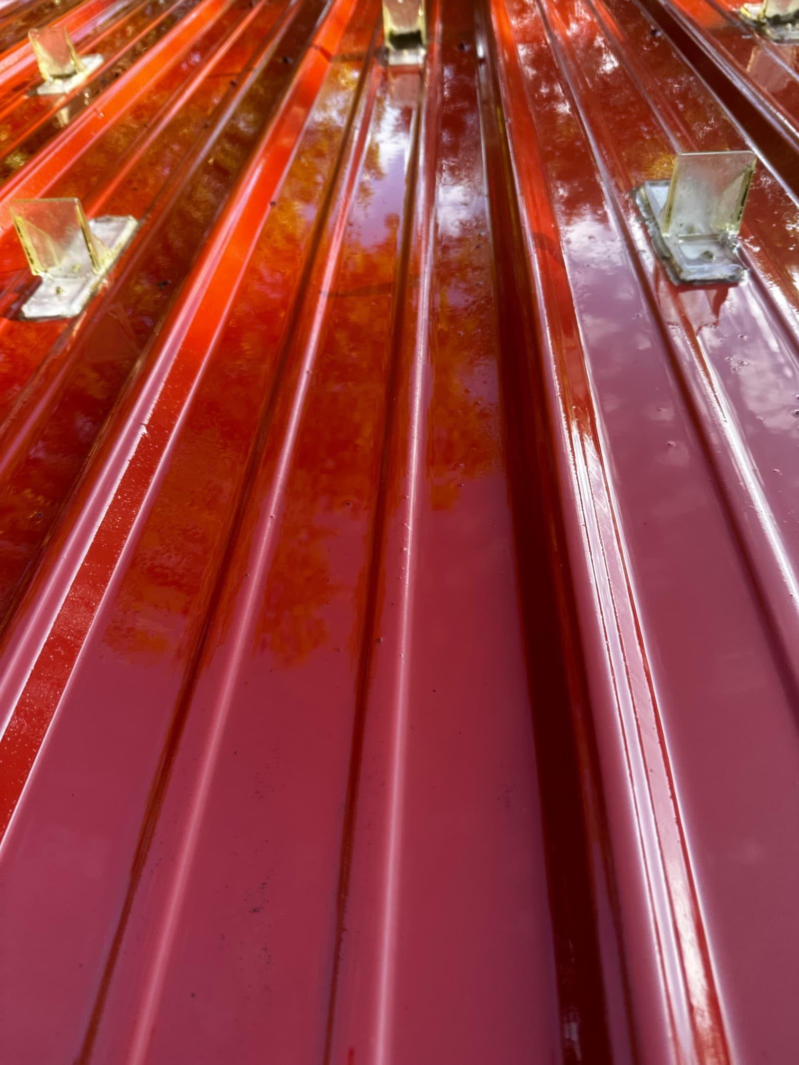 Clean red metal roof with reflective surface in Lowell, Indiana