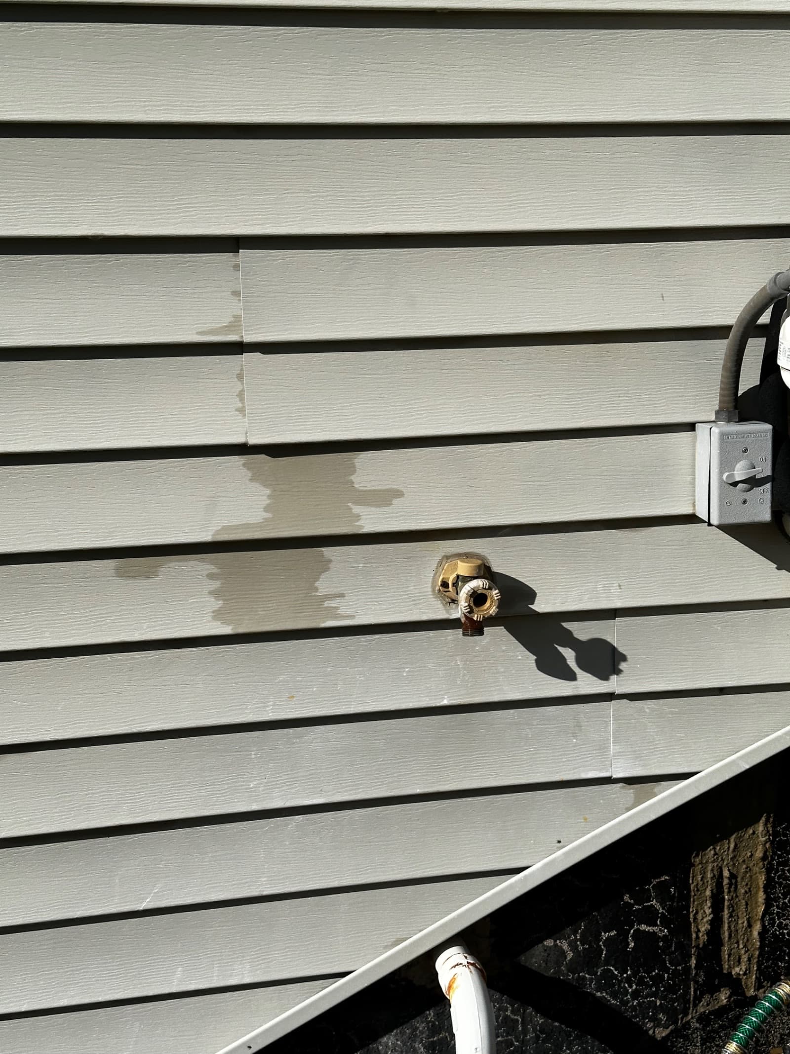 Vinyl siding with partial cleaning showing dirt removal