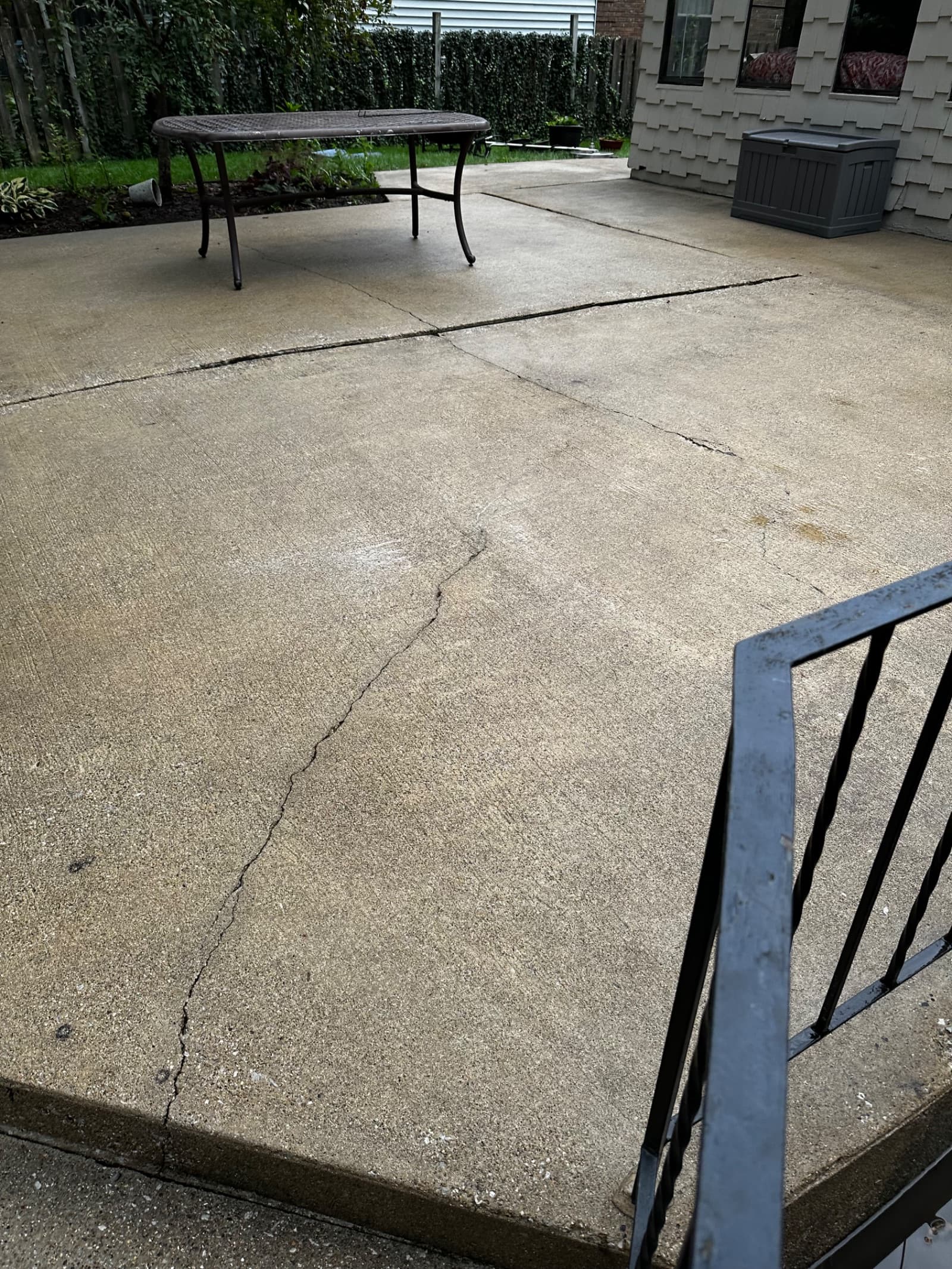 Concrete patio with visible cracks and weathering in Crown Point, Indiana.