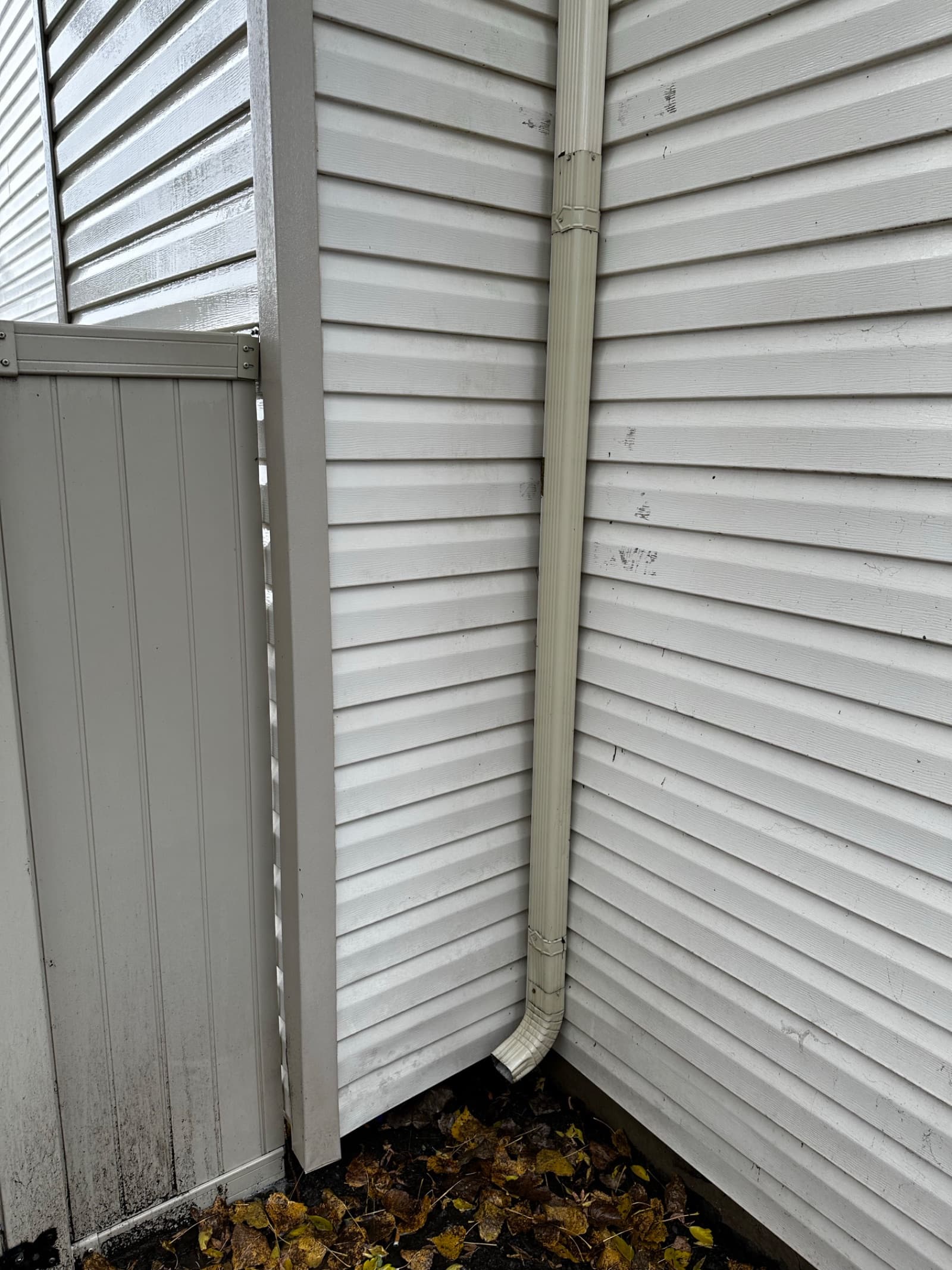 Clean white vinyl siding with downspout in Wheatfield, Indiana