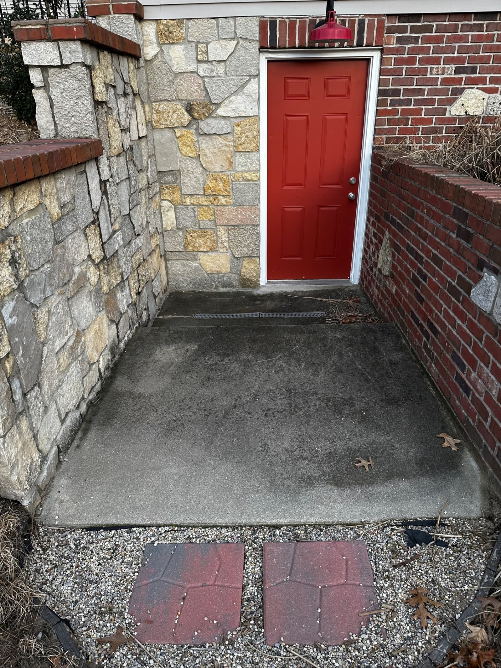 Concrete patio with dark stains before cleaning in Demotte, Indiana