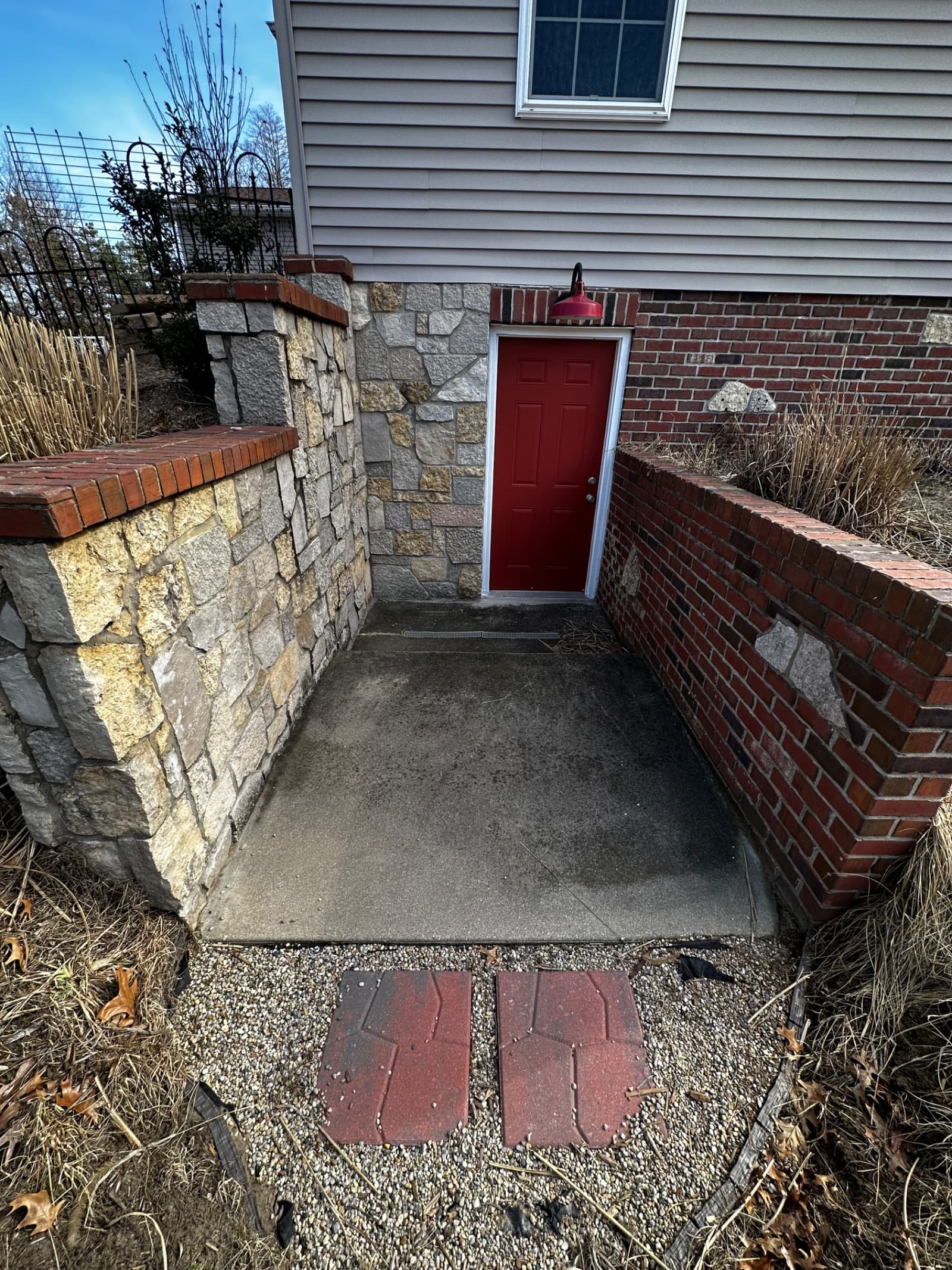 Concrete entryway with light stains and brick walls in Demotte, Indiana