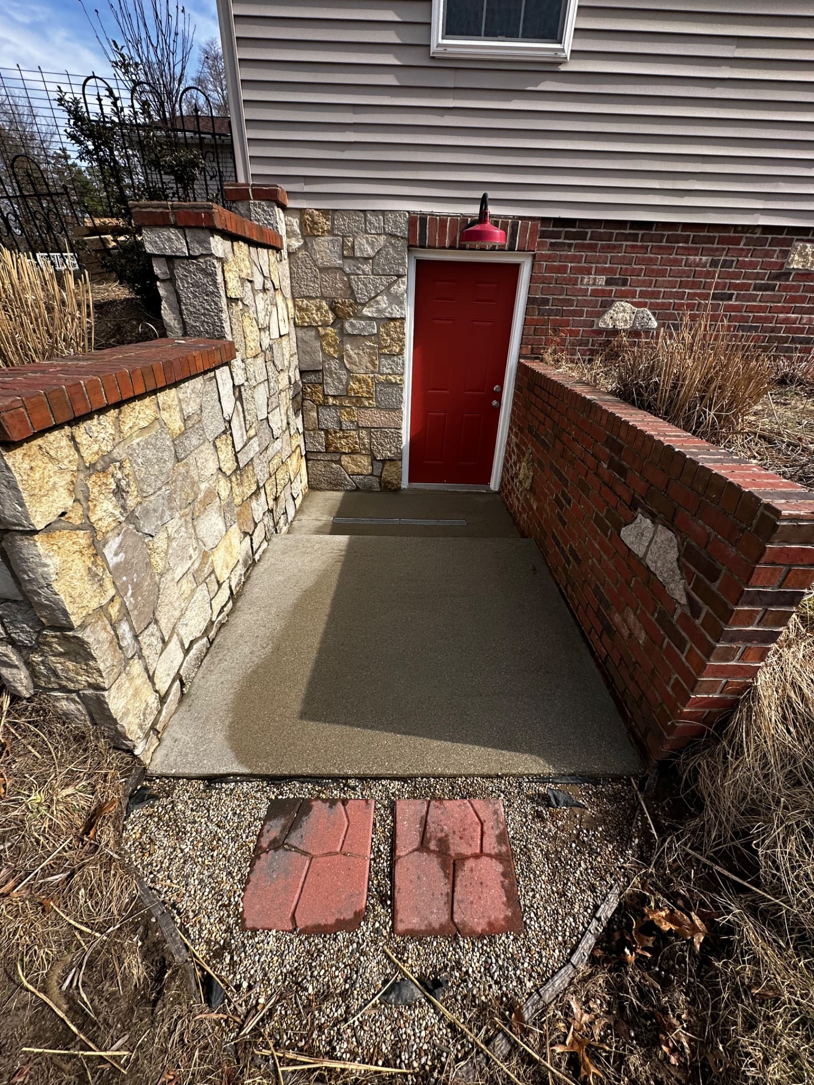 Clean concrete walkway with red brick walls in Demotte, Indiana