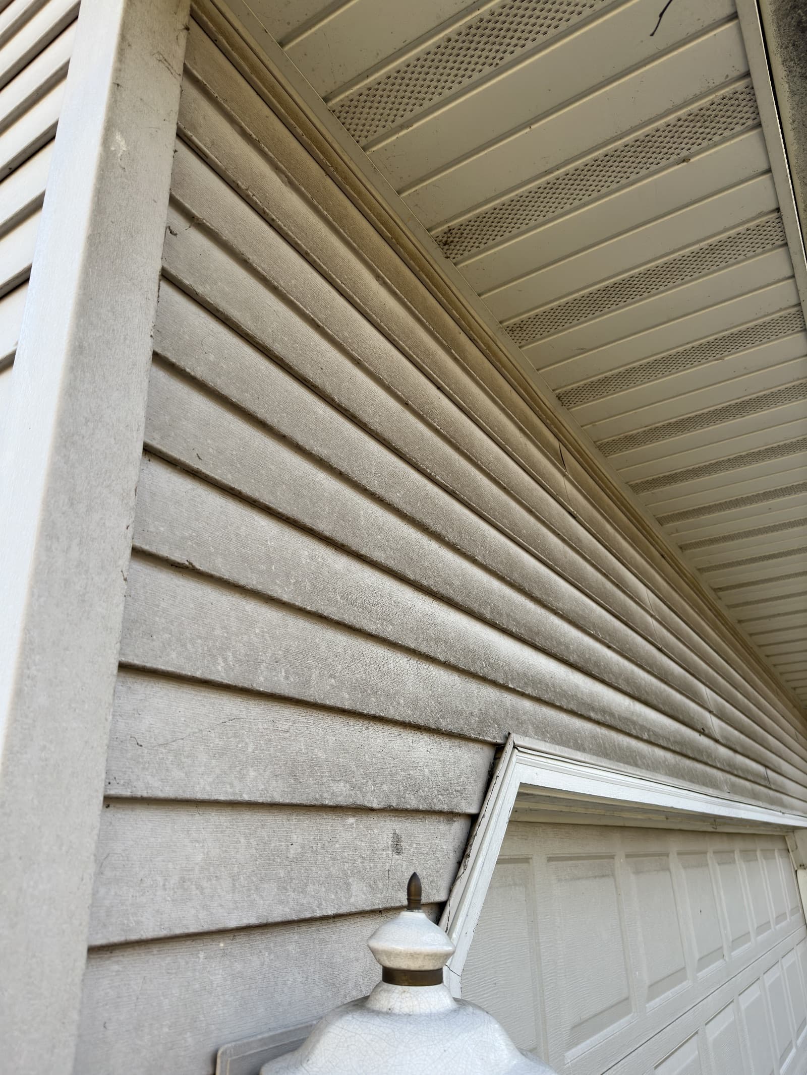 Dirty vinyl siding with visible grime and stains