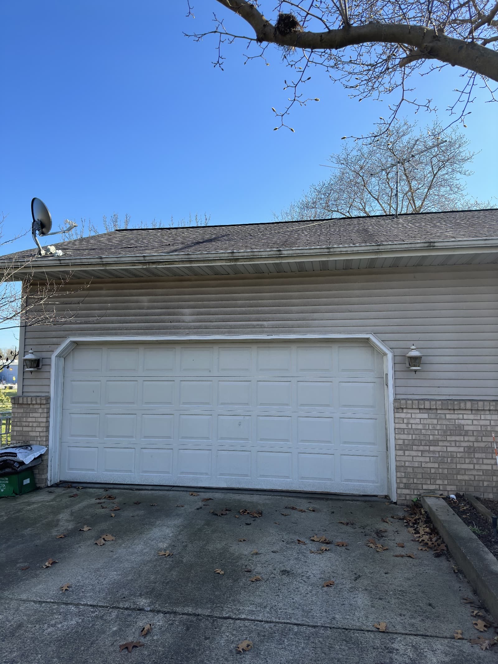 Vinyl siding with dirt stains above garage in Wheatfield, Indiana