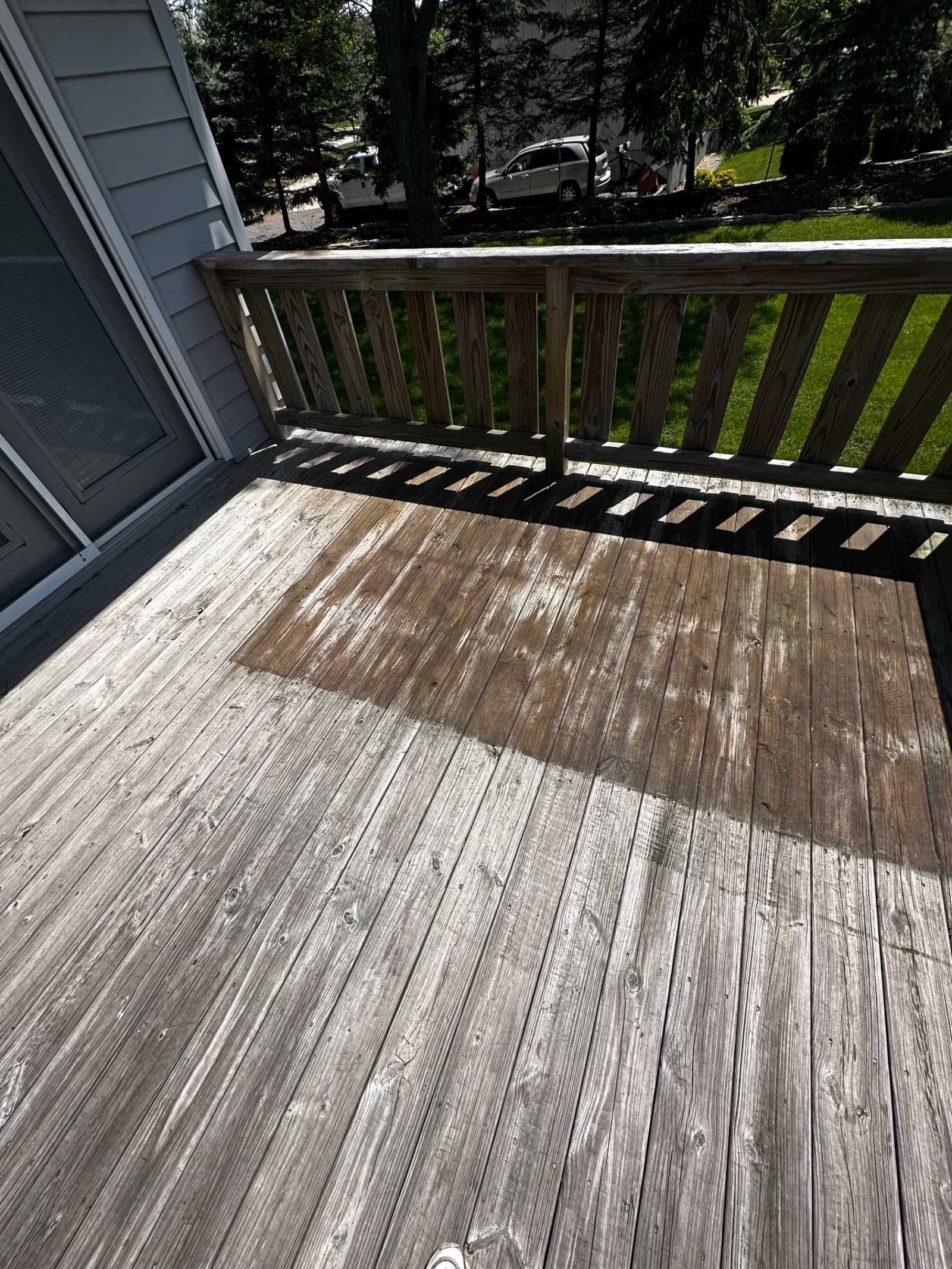Wooden deck with partially cleaned surface showing contrast