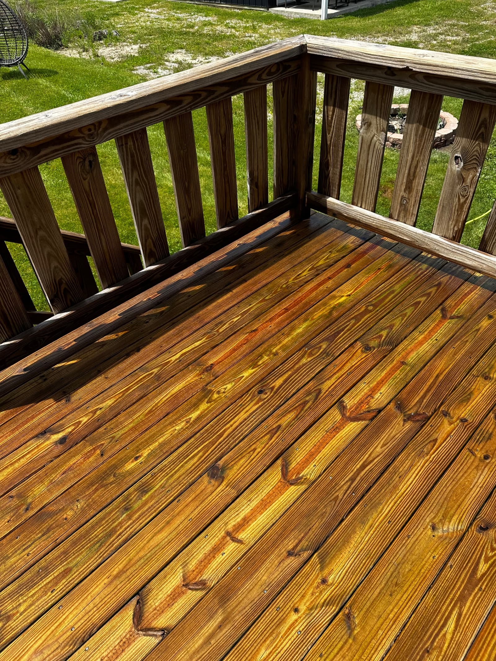 Freshly cleaned wooden deck with bright finish in sunlight