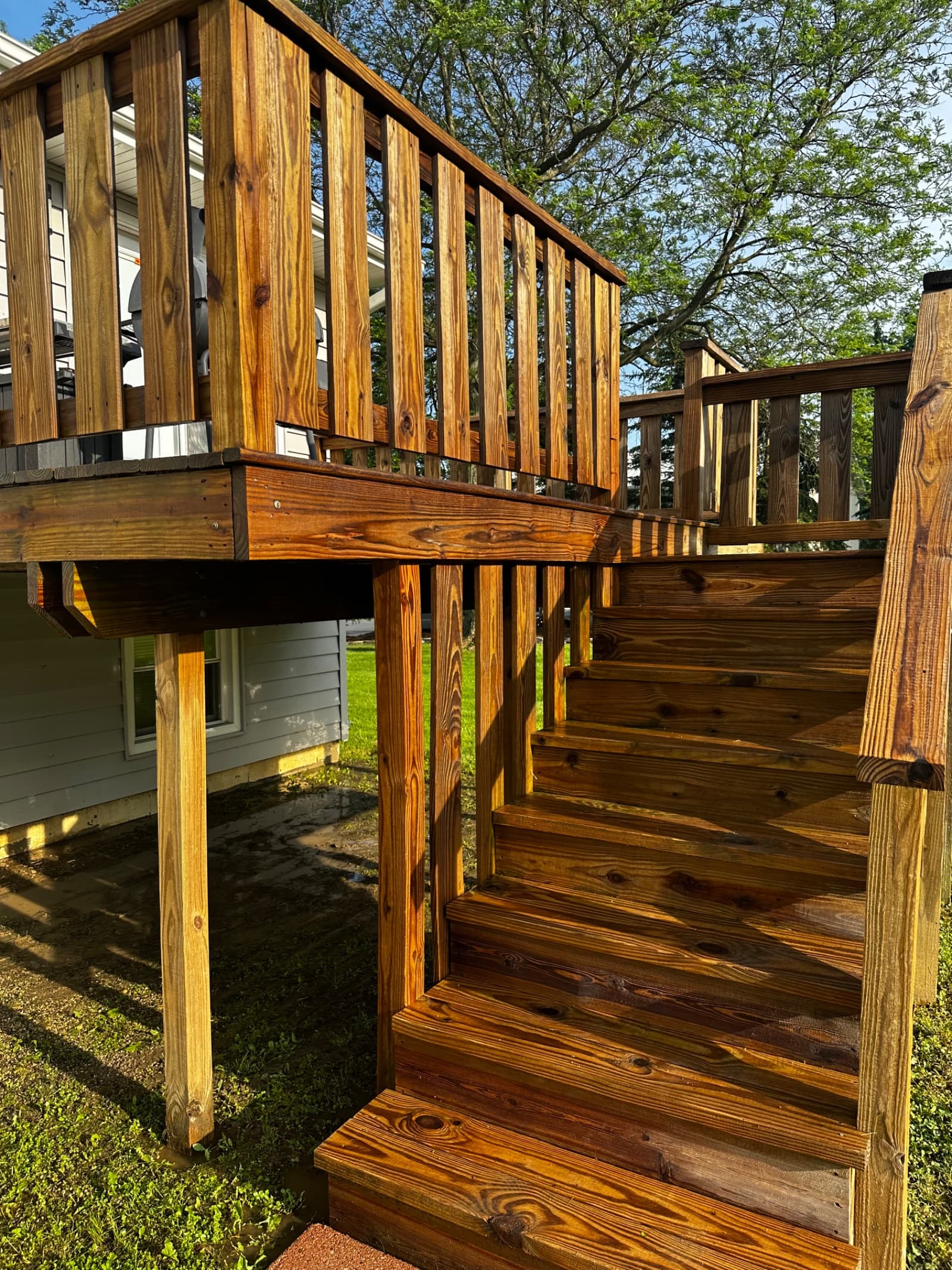 Clean wooden deck and stairs with sunlight in Crown Point, Indiana.