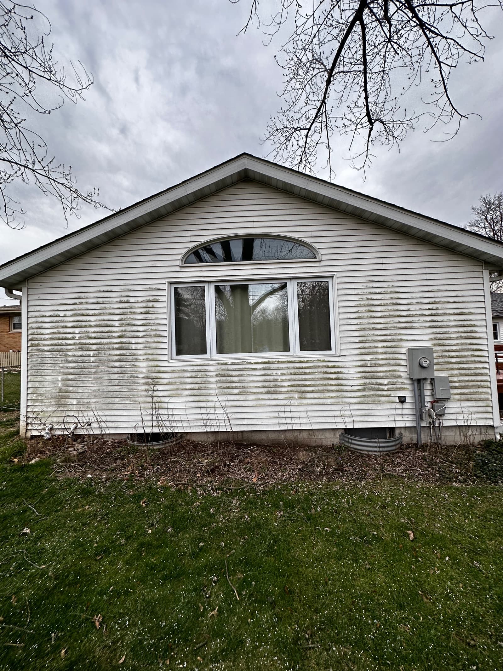 Algae-stained white vinyl siding on house in Valparaiso, Indiana.