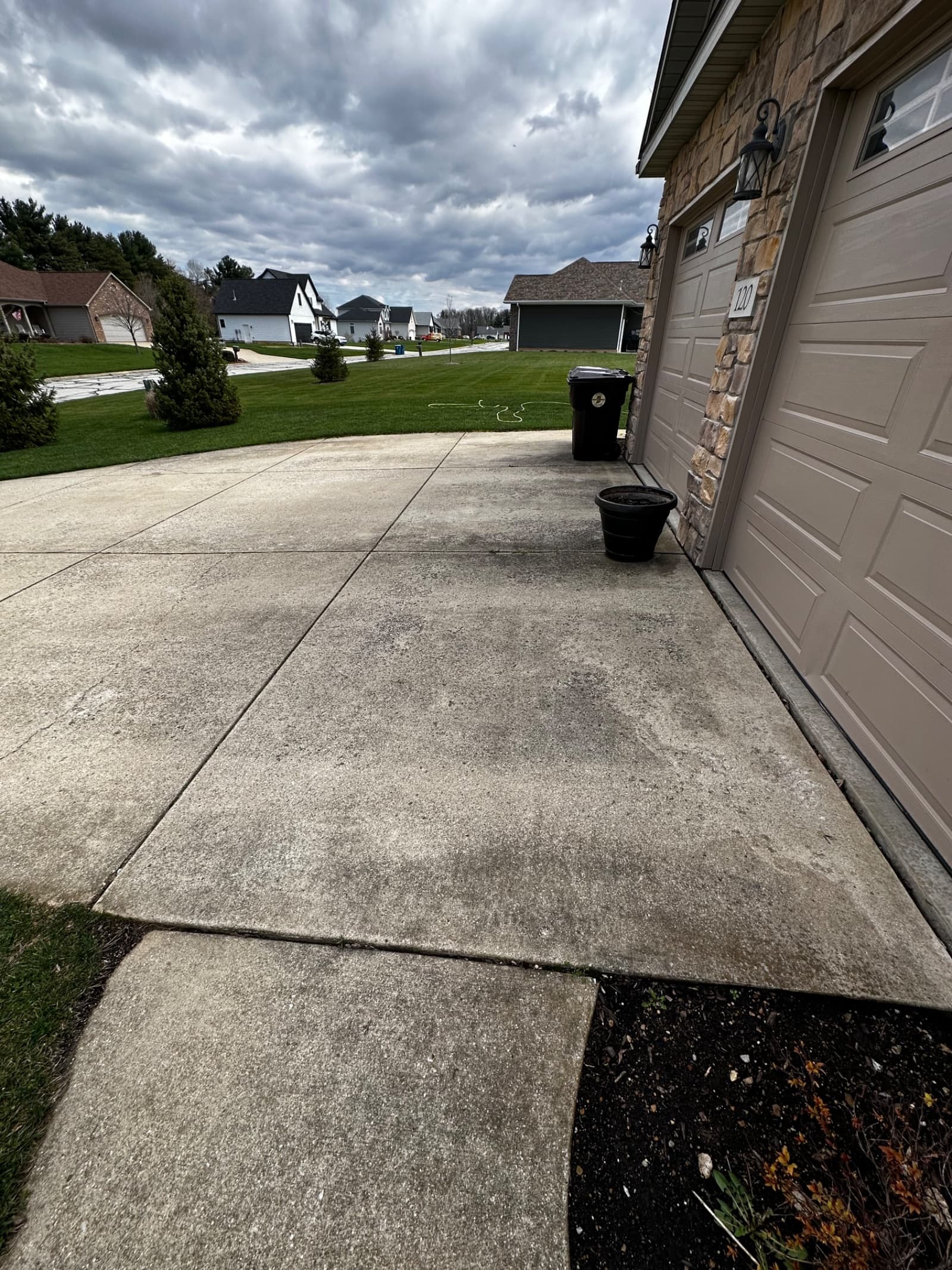 Concrete driveway with light stains before cleaning in Crown Point, Indiana.