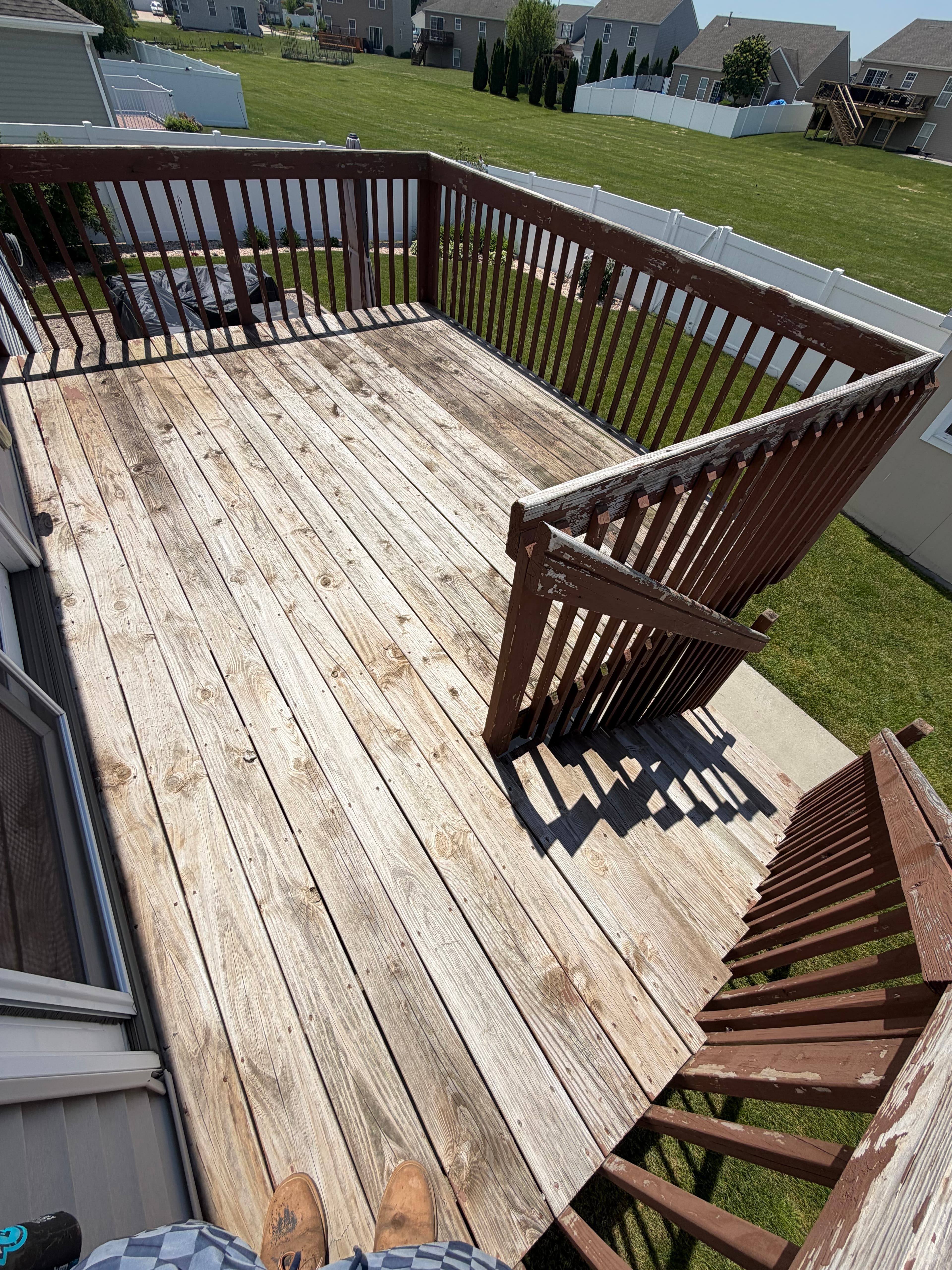 Weathered wooden deck before cleaning, showing dirt and discoloration. Deck Cleaning in Crown Point, Indiana.