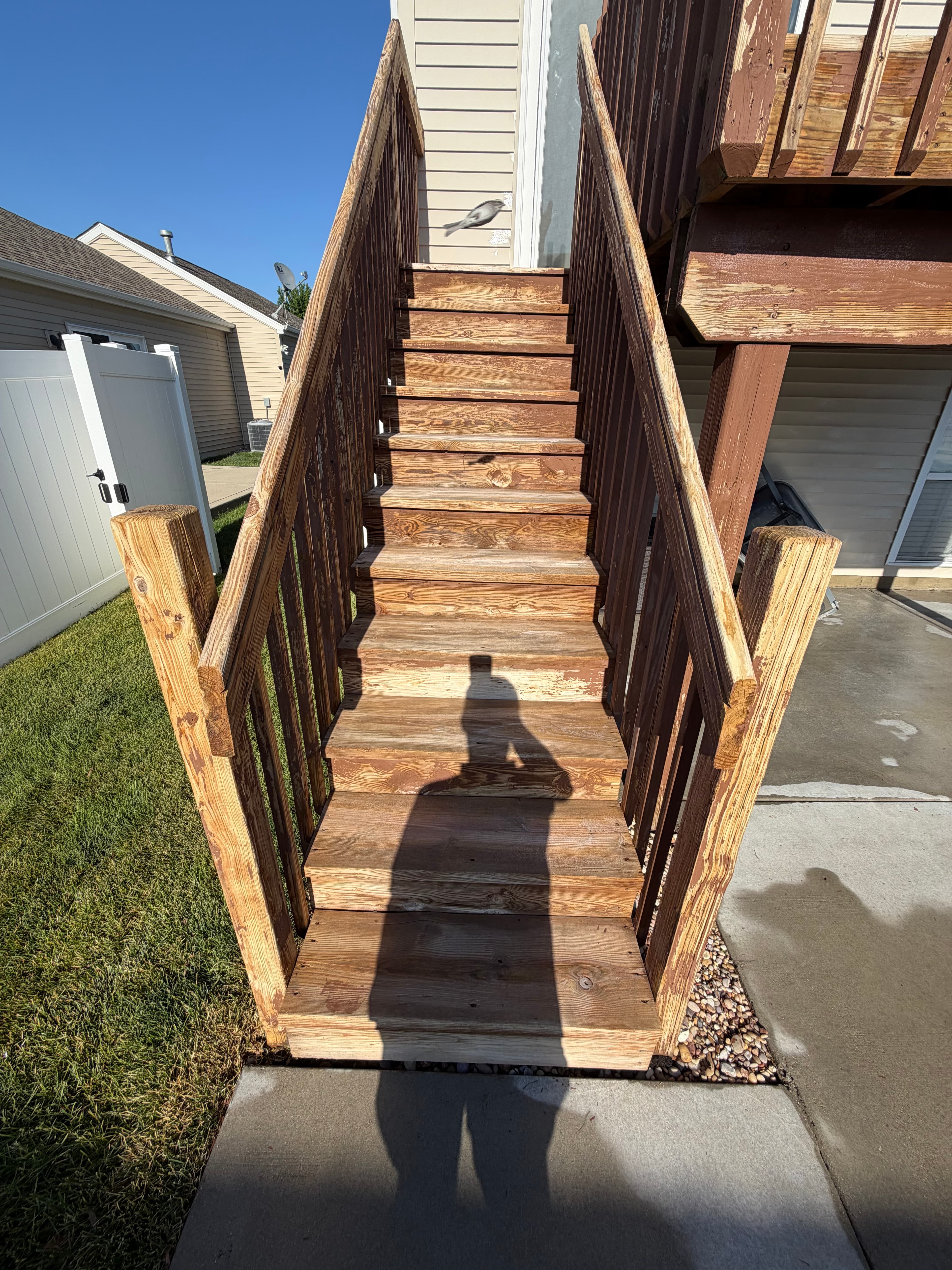 Pressure-washed wooden deck stairs, clean and restored, in Crown Point, Indiana.